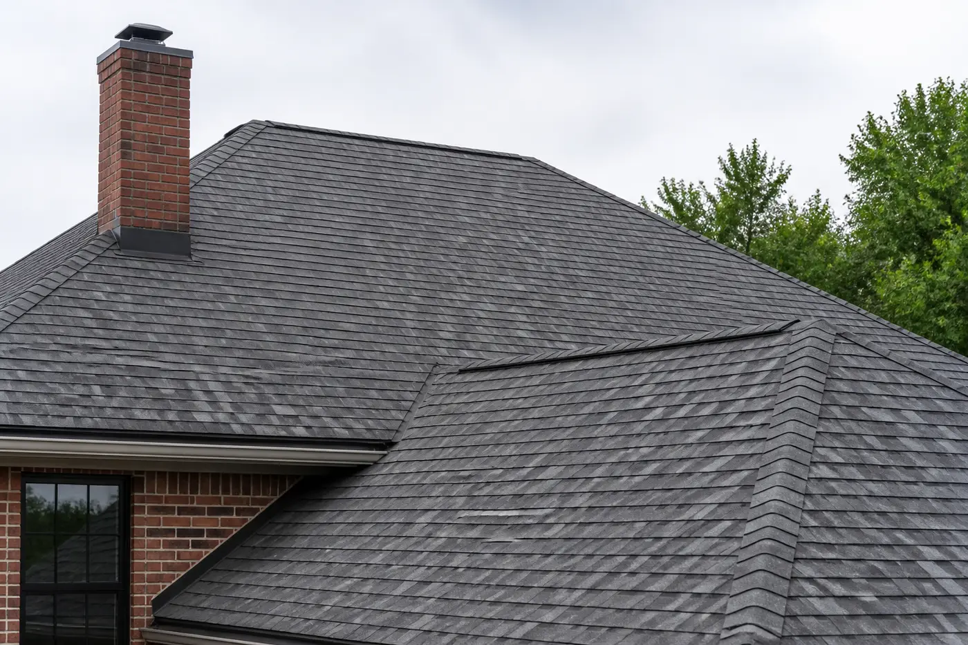 Newly installed asphalt shingle roof with finished flashing