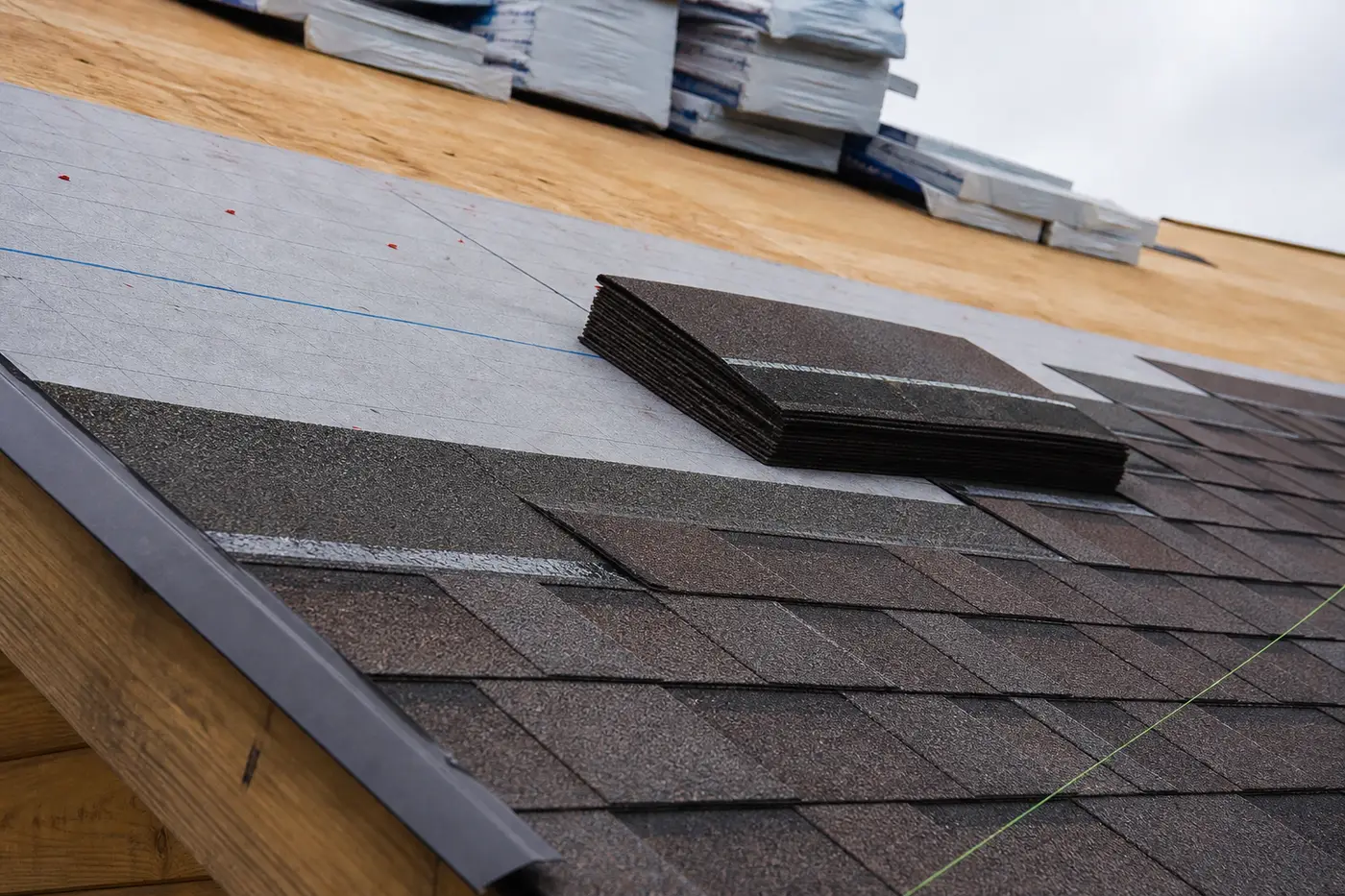New shingles being installed on a roof deck